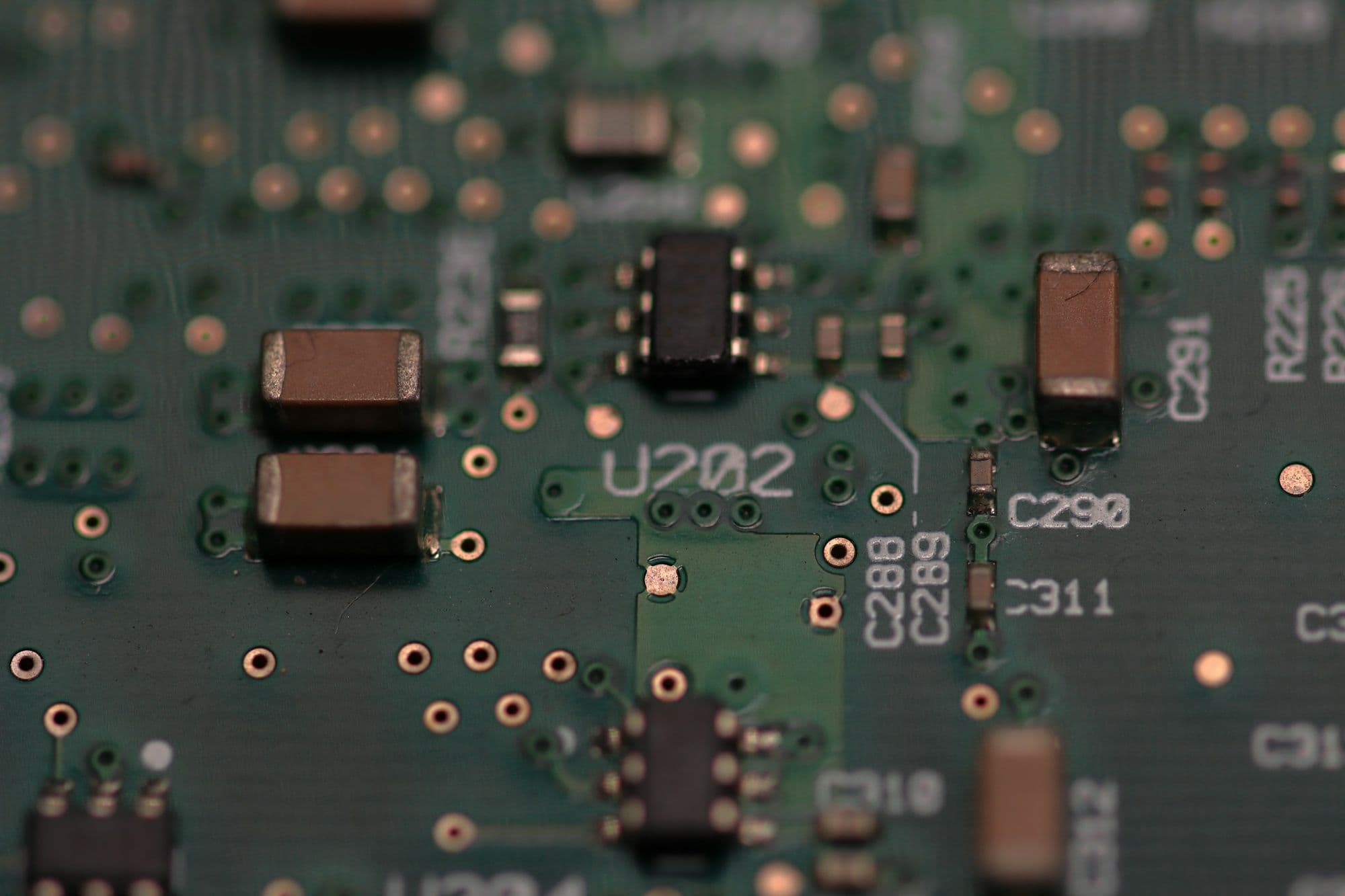Macro photograph of a printed circuit board with surface-mounted electronic components